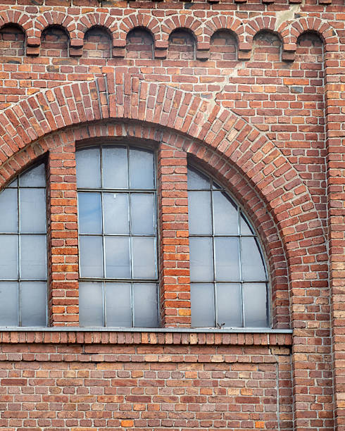 istock Historic brick architecture features large arched windows showcasing craftsmanship in a well-preserved building 2253786956