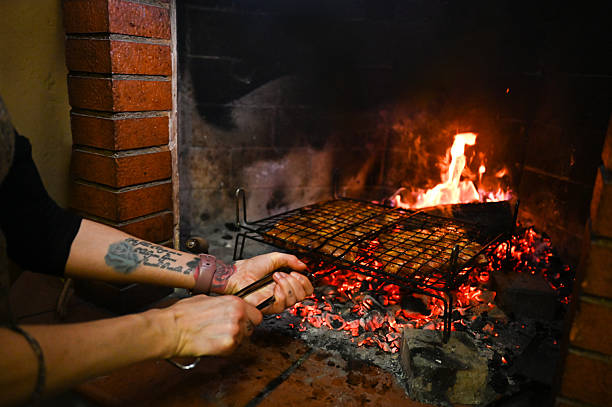 istock Person grilling meat over glowing charcoal in fireplace 2253789653