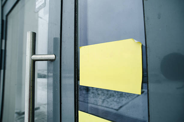 Yellow Notice On Glass Door Announcing Temporary Closure For Renovation, Bright Adhesive Tape Near Metal