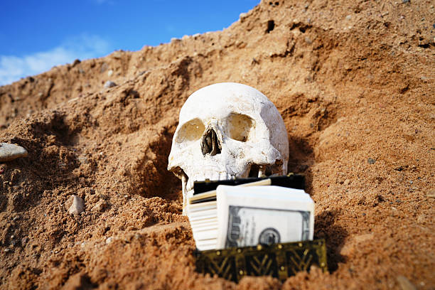 Studio shot of a pirate skeleton with a sword in the mourh
