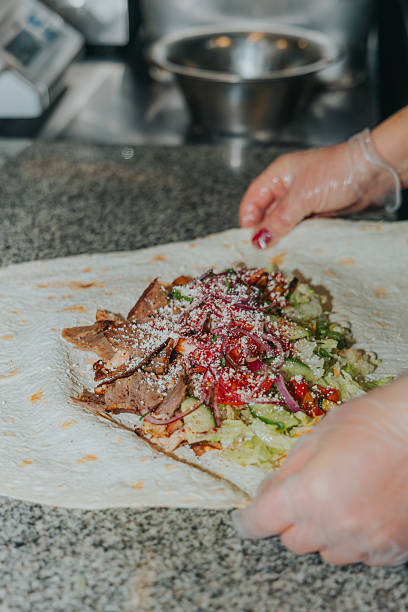 istock The process of preparing shawarma kebab. Chef's hands. Sauces, vegetables, meat 2253801443