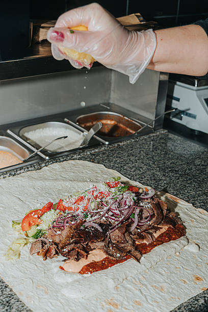 istock The process of preparing shawarma kebab. Chef's hands. Sauces, vegetables, meat 2253803251