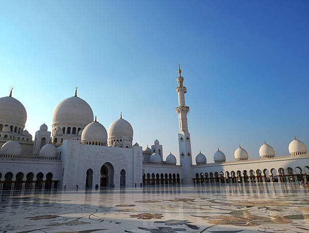 Abu Dhabi, UAE - November 29, 2025: Sheikh Zayed Mosque sunlit against the blue sky at sunset