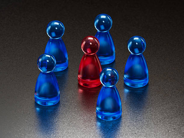 istock Standout Red Token: Contrast in a Group of Blue Game Pieces 2253805766