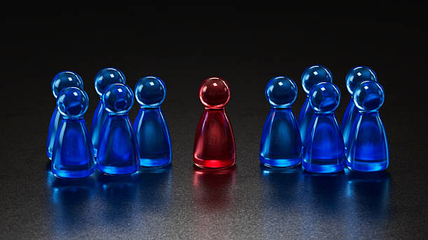 istock Standout Red Token: Contrast in a Group of Blue Game Pieces 2253805767