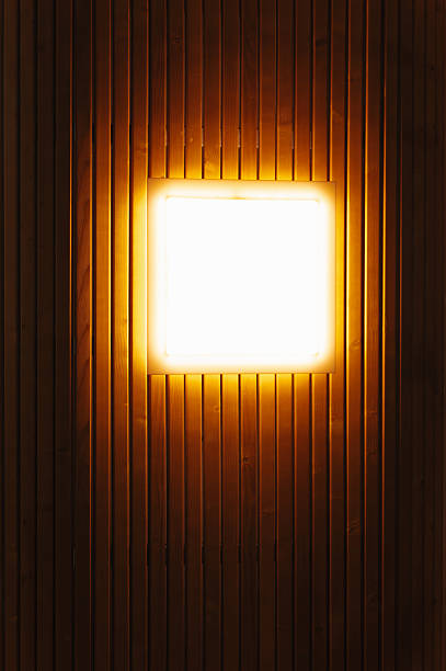 Vertical Illuminated Square On Wood Wall Portrait Framing Emphasizes Texture And Depth Warm Glow Casts Soft Shadows Across Grooves