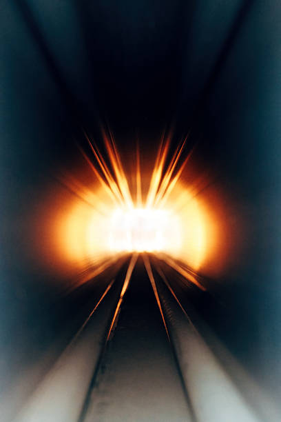 Abstract tunnel of bright light rays bursting forward motion effect, selective focus