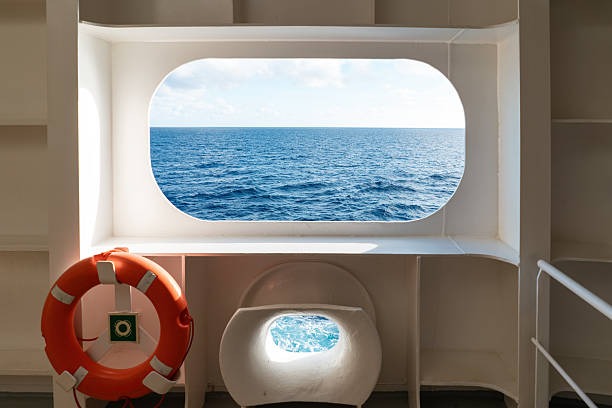 Open Sea View through window on a ships deck with lifebuoy near