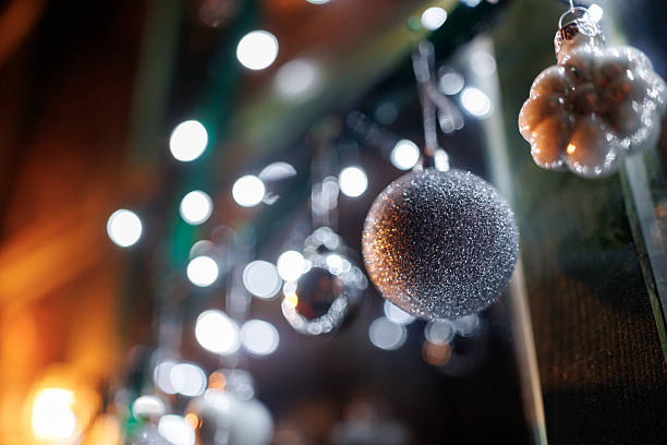 istock Silver colored ornaments and Christmas lights on window shining in night 2253810234