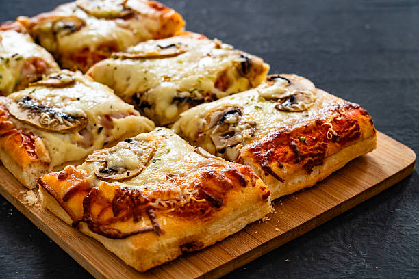 istock Pizza mushroom al metro with basil leaves on black background 2253811547