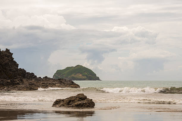 The beach at Playa Espadilla in Manuel Antonio, Costa Rica on a cloudy day.