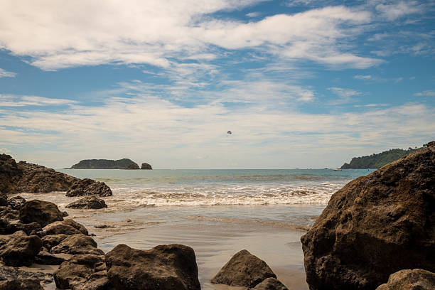 The beach at Playa Espadilla in Manuel Antonio, Costa Rica on a cloudy day.