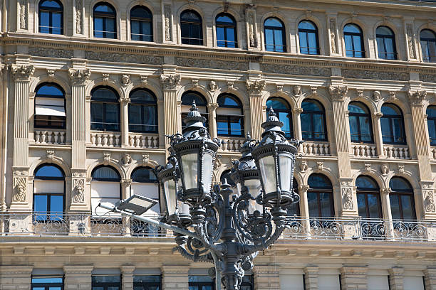 An intricate designed lamp in front of the landmark Opera house in Frankfurt Germany.