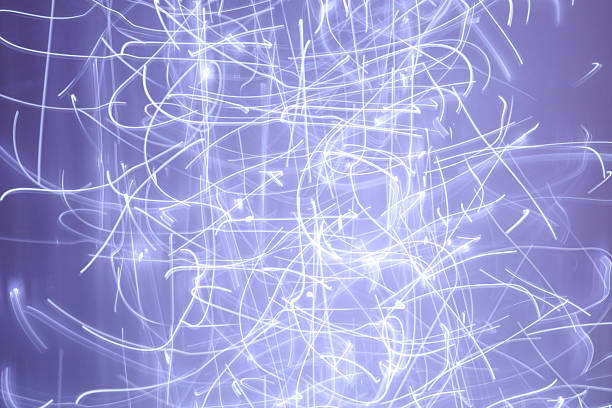 ​An abstract composition of chaotic light lines creates a dynamic effect of motion against a soft purple background.