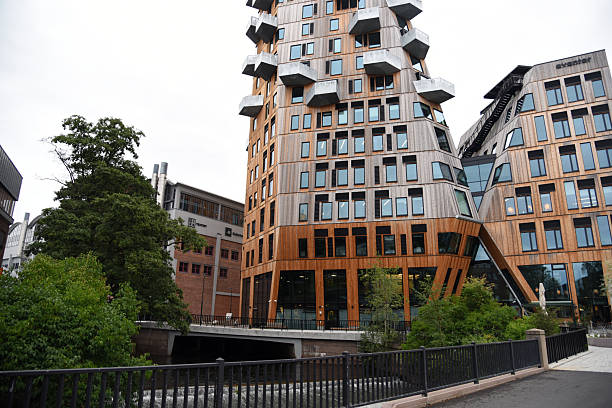 Oslo, Norway July 31,2025:Vertikal Nydalen is located in the Nydalen district of Oslo, a former industrial area on the Akerselva River. The image shows Vertikal Nydalen on a cloudy day during summer season - the building was completed in 2024 and realized after plans by Snøhetta Architect Office.