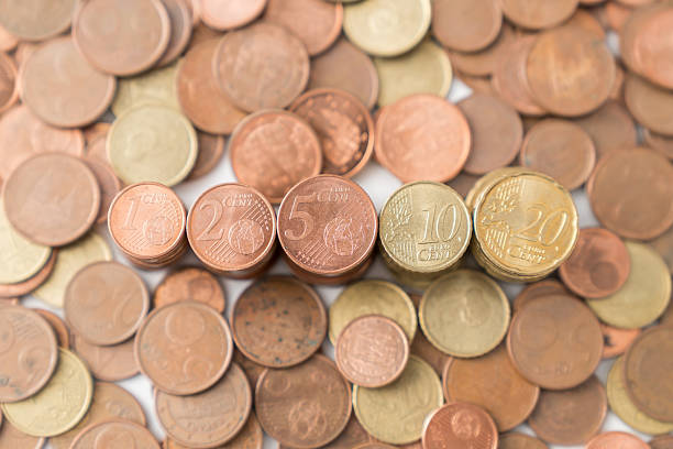 Euro coins in stacks and spread out representing finance, economy, and investment