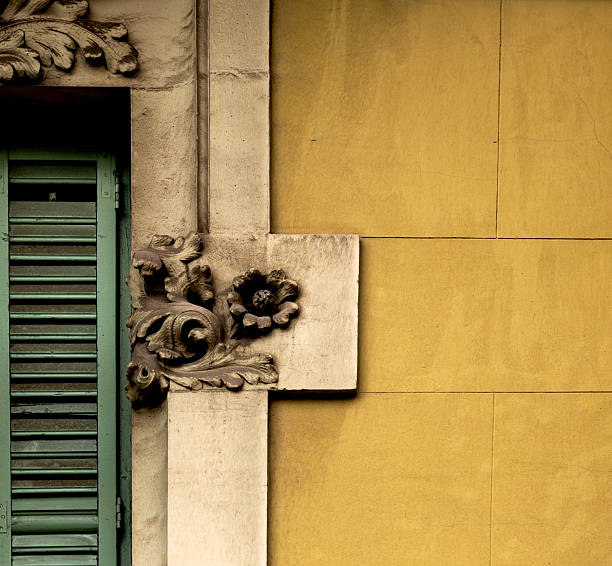 istock small flower in the window frame next to the yellow wall 2253830455
