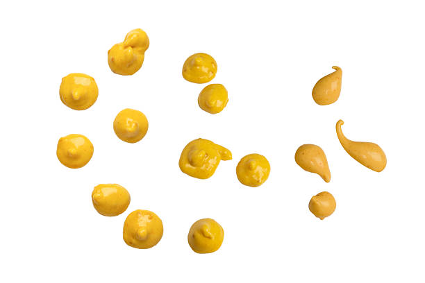 Yellow sauce splashes isolated on white background.  Top view.