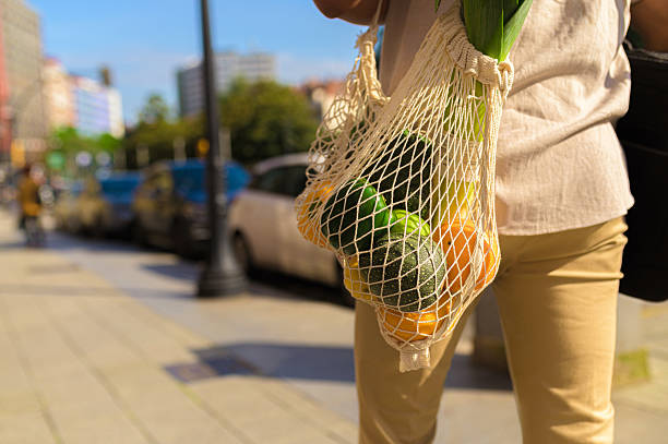 istock Person carrying reusable mesh bag with vegetables 2253833139