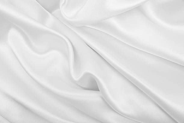 istock Smooth elegant white silk or satin luxury cloth texture as wedding background. Luxurious background design 2253833959