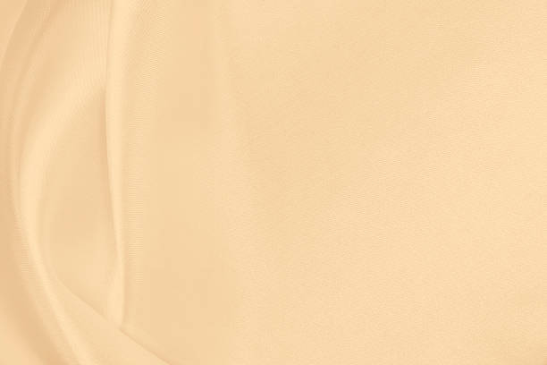 istock Smooth elegant golden silk or satin luxury cloth texture as wedding background. Luxurious Christmas background or New Year background design. In Sepia toned. Retro style 2253834102