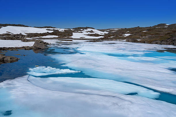 Fantesteinsvatnet lake reflection, turquoise ice, Jotunheimen National Park, Sognefjellet Route 55, Norway summer