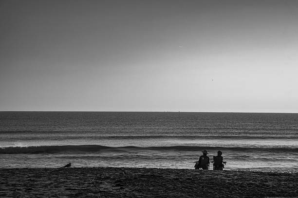 Unidentified fishermen, in silhouette, on the beach waiting for the moment to fish. Fishing hobby. Brazil