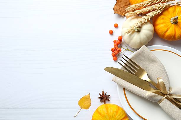 istock Rustic holiday table setup. Top view with plates, cutlery and autumn decorations. Empty space for your text 2253838671