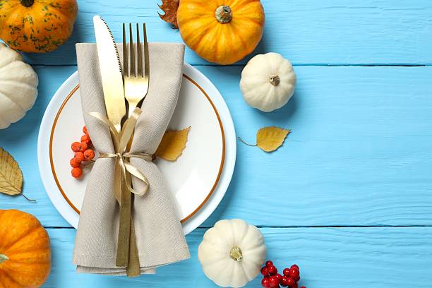 istock Rustic holiday table setup. Top view with plates, cutlery and autumn decorations. Empty space for your text 2253838674