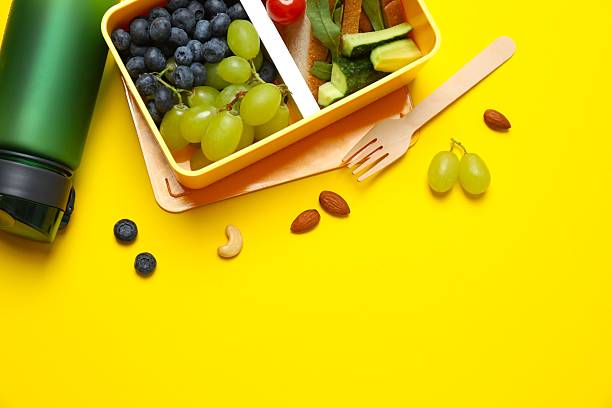 istock Packed lunch with sandwiches, fruits, nuts and vegetables in a divided container 2253839943