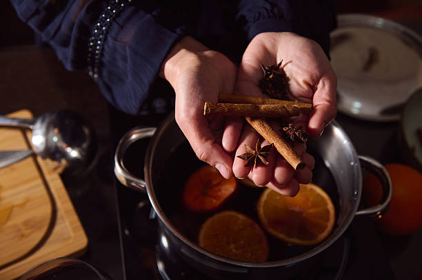 istock Warm Mulled Wine Preparation With Cinnamon Sticks And Star Anise In Cozy Winter Kitchen 2253839961