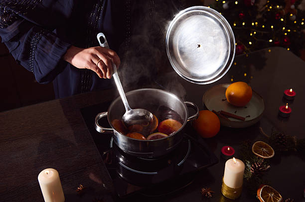 istock Winter Mulled Wine Preparation With Oranges And Spices In Cozy Holiday Kitchen Scene 2253839975