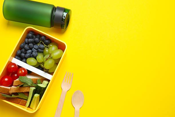 istock Packed lunch with sandwiches, fruits, nuts and vegetables in a divided container 2253839997