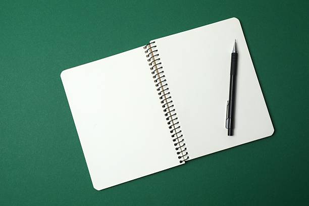 istock Flat lay with pen and notebook on dark green background, top view 2253840151