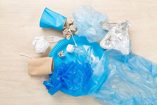 istock Bag with unsorted waste on wooden background, top view 2253840494