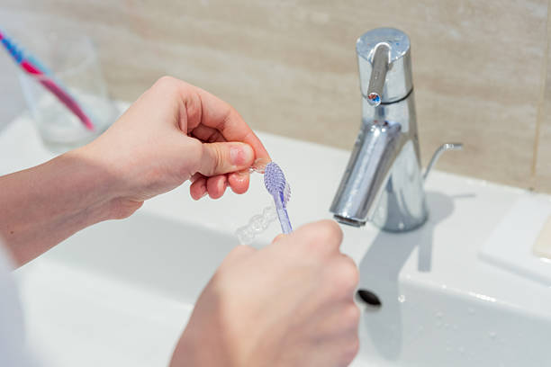 istock Teen Girl Using Modern Clear Aligner For Teeth Straightening Routine 2253841508