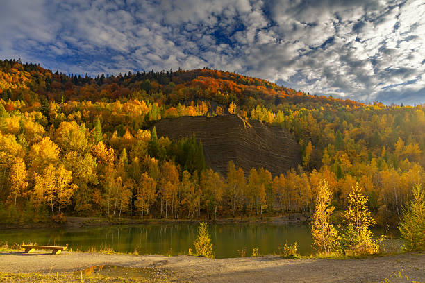 Autumn landscape in a quarry surrounded by colorful trees, Kozy, Poland, Silesian Voivodeship