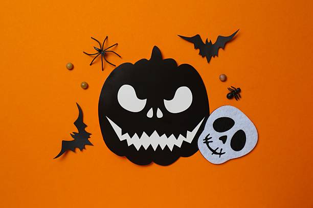 istock Halloween poscard with festive decorations on orange background . Top view, space for text 2253842190