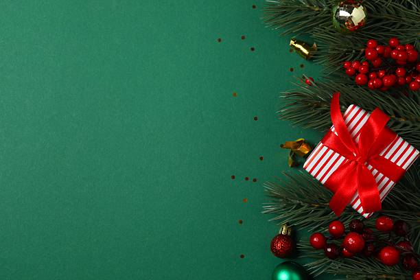 istock Vertical festive Christmas background with fir branches, gift box and different  decorations 2253843225