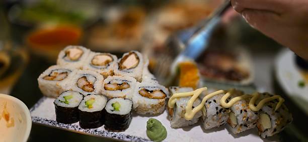 istock Dining on mixed sushi rolls with wasabi and spicy mayonnaise 2253845947