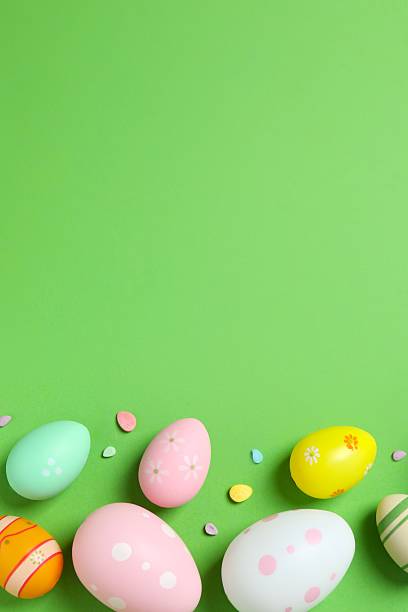 istock Happy Easter. Colorful eggs on green background, space for text or advertising 2253846030