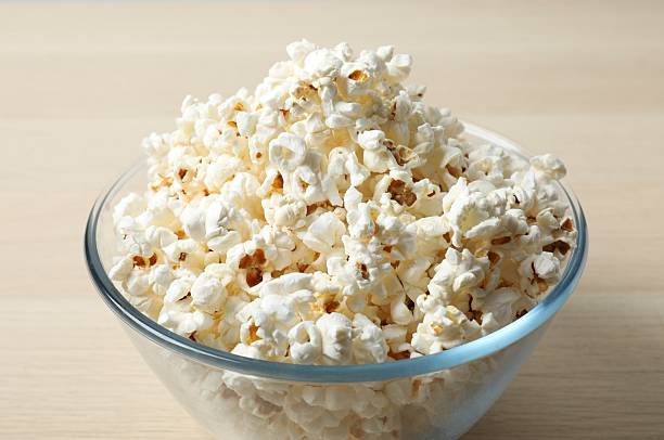 istock Popcorn in a bowl on wooden background 2253846105
