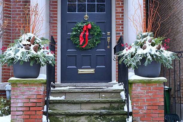 istock Front door with Christmas wreath with red bow 2253848202