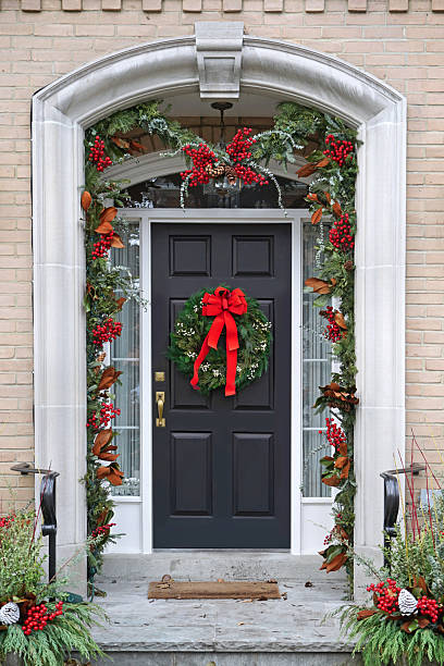 istock Front door with Christmas wreath with red bow 2253848203