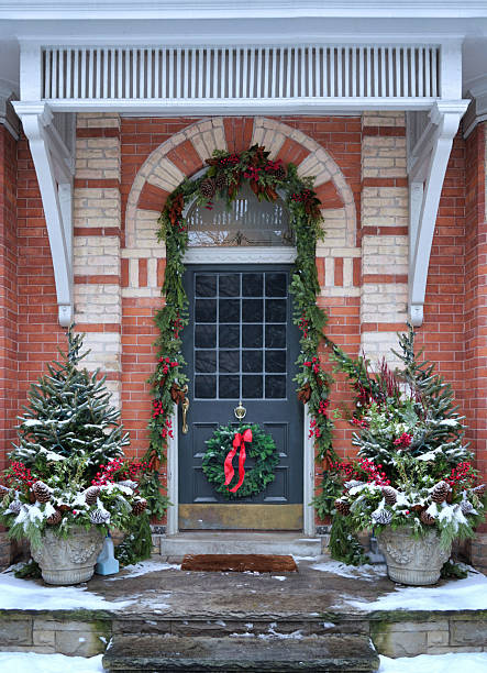 istock Front door with Christmas wreath with red bow 2253848204