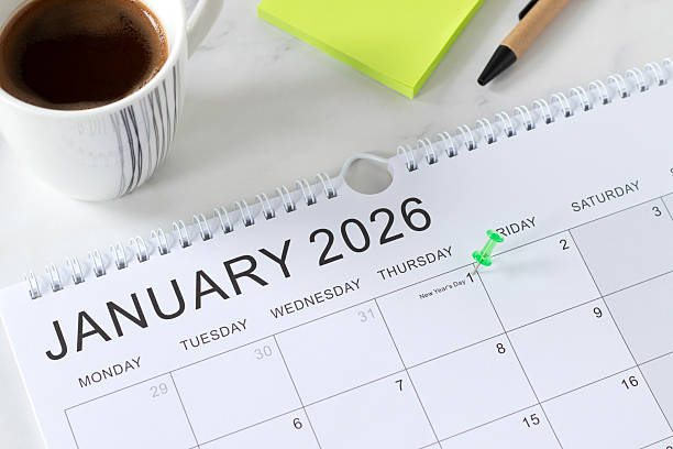 istock 2026 New year calendar, January first date with a pin on white table with coffee cup and sticky notes 2253850930