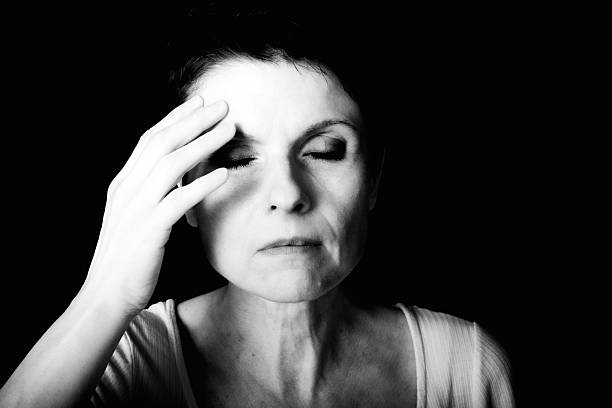 Close-up of a female person with a slightly averted gaze, gentle hand gesture, and soft high-key lighting. The hand near the face feels like a soft, unconscious gesture. A modern, poetic expression of hope, lightness, and gentle introspection.