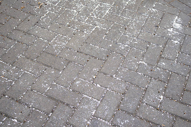 istock Winter Sidewalk with Deicing Salt Spread to Prevent Ice Formation 2253853471