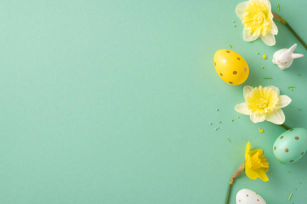 istock Pastel eggs and daffodils frame a soft green background, capturing Easter joy, renewal, and festive greeting ideas for seasonal projects and stock display 2253853605