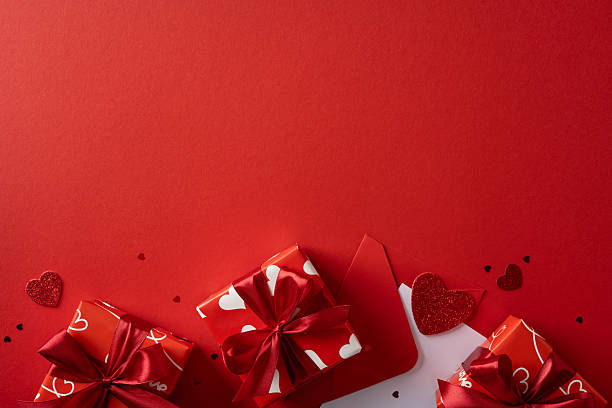 istock Red gift boxes with bows and heart patterns create a romantic Valentine scene against a bold red backdrop, ideal for love, gift, and greeting campaigns 2253853706